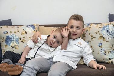 Adam Sadlah, left pictured with brother Anas at their home in Sharjah, underwent surgery for a congenital heart abnormality in Abu Dhabi. Antonie Robertson / The National