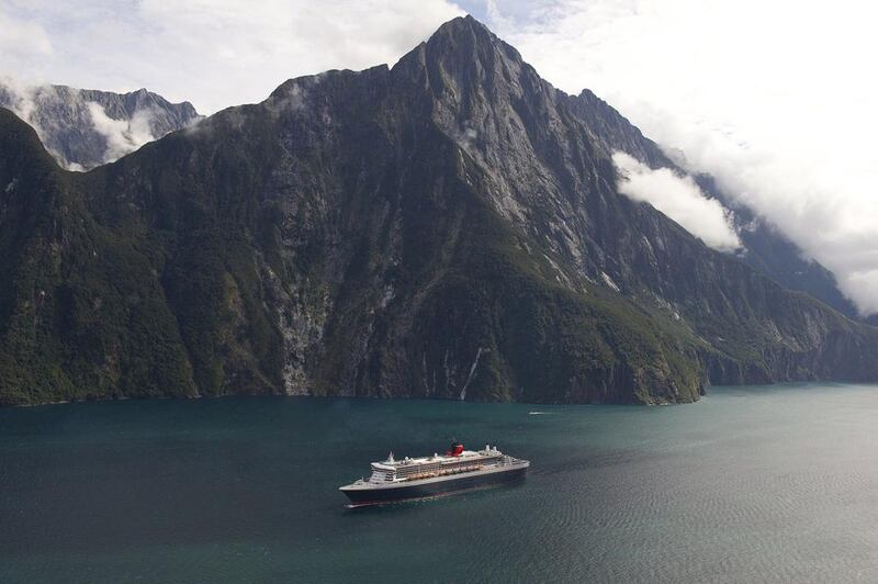 Emirates' A380 service to New Zealand will give visitors the chance to experience locations from The Hobbit such as Fiordland National Park. Here Cunard's Queen Mary 2 luxury liner plies Milford Sound in the park. James Morgan / Cunard / AFP