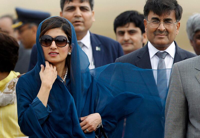 PakistanÕs newly installed Foreign Minister Hina Rabbani Khar arrives at the airport in New Delhi, India, Tuesday, July 26, 2011. Khar is here to meet with her Indian counterpart S.M. Krishna Wednesday. Indian and Pakistani officials began talks Tuesday against the backdrop of a recent terror attack that killed 20 people in India's financial capital. At right is India`s high Commissioner to Pakistan Sharat Sabharwal. (AP Photo/Gurinder Osan)