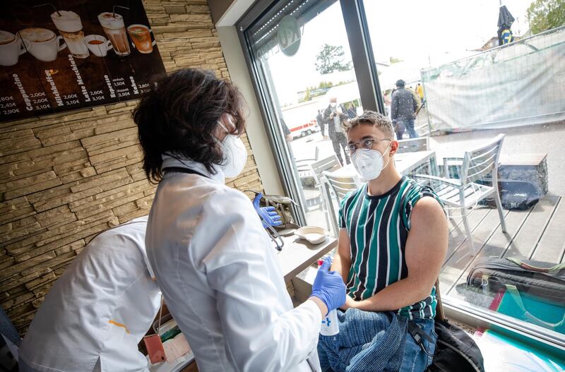 05 May 2021, Baden-Wuerttemberg, Pforzheim: A young man gets vaccinated with the Astrazeneca vaccine in a supermarket. A doctor and her team vaccinate around 250 doses of Astrazeneca, for which she found no takers in her consultation hours because of the distrust of the active ingredient - No appointment was needed for the action. Photo: Christoph Schmidt/dpa (Photo by Christoph Schmidt/picture alliance via Getty Images)