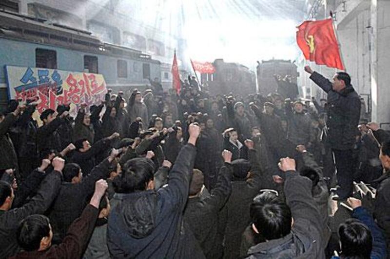 Workers at the Kim Jong Tae Electric Locomotive Combined Plant honour Kim Jong-il in Pyongyang yesterday.