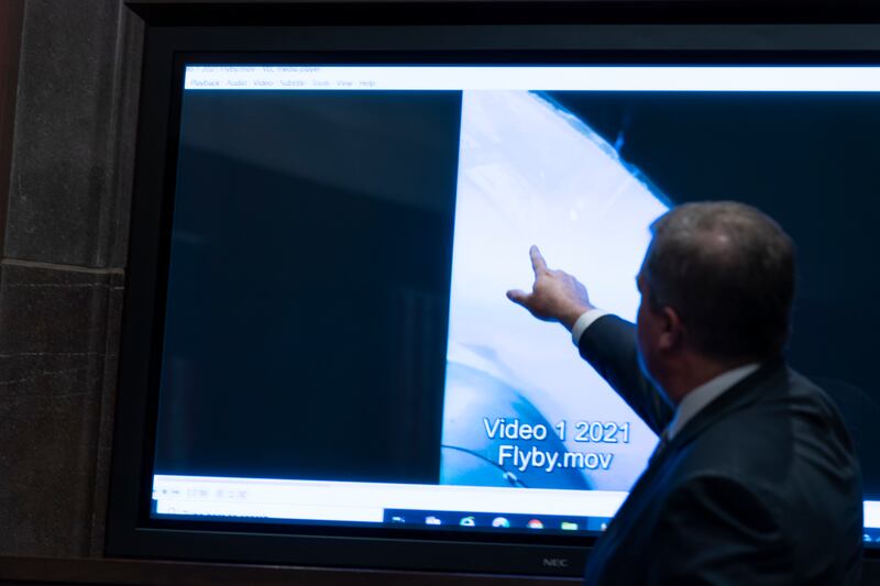 Deputy Director of Naval Intelligence Scott Bray points to a video display of an unexplained aerial phenomenon during a 2022 hearing. AP