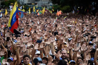People raise their hands during a mass opposition rally against President Nicolas Maduro in Caracas last week. Federico Parra / AFP 
