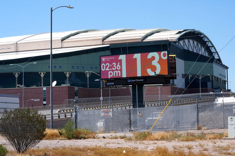 At Chase Field in Phoenix, Arizona, a billboard updates the time and record high temperature, which translates to 45ºC. AP