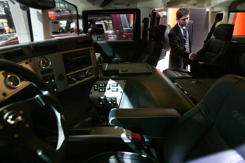 NEW YORK - APRIL 12:  A member of the press looks through the interior of a Hummer H1 Diesel on April 12, 2006 at the 2006 New York International Auto Show in New York City. The show is open to the public from April 14-23. (Photo by Chris Hondros/Getty Images)