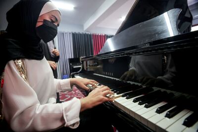 A student plays on Gaza's only grand piano at the Edward Said National Conservatory of Music in Gaza. Mustafa Mohamad for The National