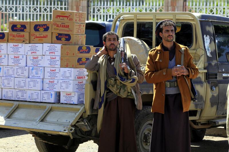 epa07151218 Armed supporters of Houthi rebels stand near a car carrying food supplies during a gathering to collect food aid and mobilize more fighters into Hodeidah battlefronts, in Sana'a, Yemen, 08 November 2018. According to reports, supporters of Houthi rebels have delivered food supplies and more fighters to support Houthi militias and allied troops fighting Saudi-backed Yemeni government forces in the key port city of Hodeidah, a week after the government forces with the support of the Saudi-led military coalition intensified their attack against the Houthis-controlled port city which the government have been seeking to recapture since June 2018.  EPA/YAHYA ARHAB