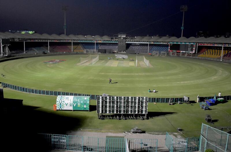 Groundsmen finalize the arrangements for upcoming first match of Pakistan Super League T20 cricket tournament at the National Stadium, in Karachi, Pakistan, Friday, Feb. 19, 2021. Spectators will return to cricket stadiums in Pakistan for the first time since the coronavirus pandemic began when the sixth edition of the Pakistan Super League begins in the southern port city of Karachi on Saturday. (AP Photo/Fareed Khan)