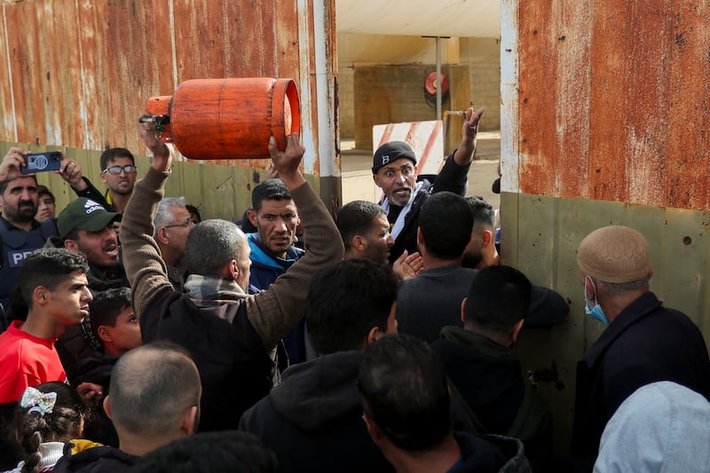 Gazans gather at the Rafah border crossing to receive fuel during a pause in the war. Reuters