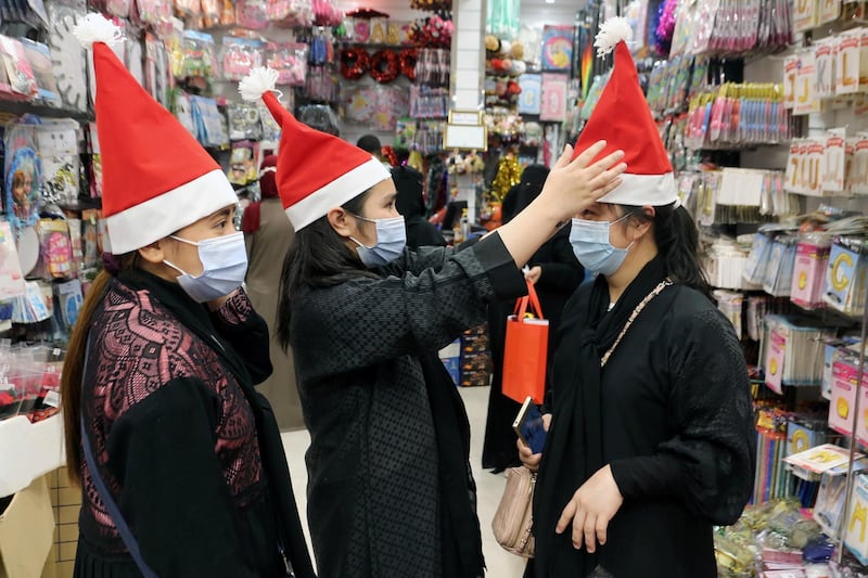 People buy Christmas hats from a shop selling various items for Christmas celebrations, after the government eased restrictions on the sale of Christmas ornaments and decorations, in Riyadh, Saudi Arabia.  Reuters