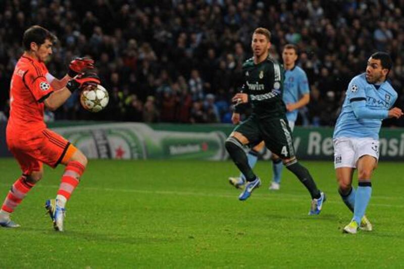 Manchester City striker Carlos Teves has his shot saved by Real Madrid goalkeeper Iker Casillas