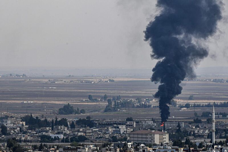 This picture taken on October 18, 2019 from the Turkish side of the border at Ceylanpinar district in Sanliurfa shows fire and smoke rising from the Syrian town of Ras al-Ain on the first week of Turkey's military operation against Kurdish forces. Sporadic clashes between Turkish forces and Kurdish groups were ongoing in a battleground Syrian border town on October 18, a monitor said, despite Ankara's announcement of a five-day truce. / AFP / Ozan KOSE
