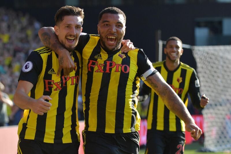Watford's Northern Irish defender Craig Cathcart (L) celebrates with Watford's English striker Troy Deeney after scoring their second goal during the English Premier League football match between Watford and Tottenham Hotspur at Vicarage Road Stadium in Watford, north of London on September 2, 2018. (Photo by OLLY GREENWOOD / AFP) / RESTRICTED TO EDITORIAL USE. No use with unauthorized audio, video, data, fixture lists, club/league logos or 'live' services. Online in-match use limited to 120 images. An additional 40 images may be used in extra time. No video emulation. Social media in-match use limited to 120 images. An additional 40 images may be used in extra time. No use in betting publications, games or single club/league/player publications. / 