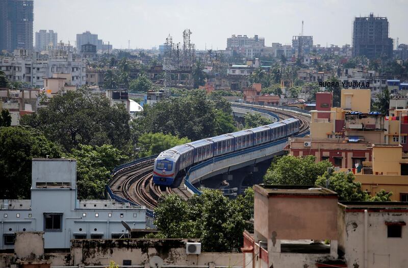 A metro train carrying staff members moves through a residential area ahead of the restart of its operation, amid the spread of the coronavirus in Kolkata, India. Reuters