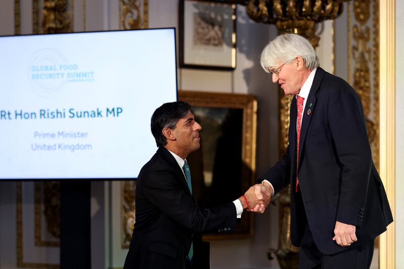Mr Sunak shakes hands with Britain's Minister of State for Development and Africa, Andrew Mitchell. PA