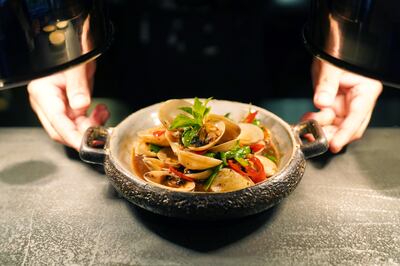 Wok fried clams with black bean, XO sauce and spring onions at Hawkerboi. Photo: EatX