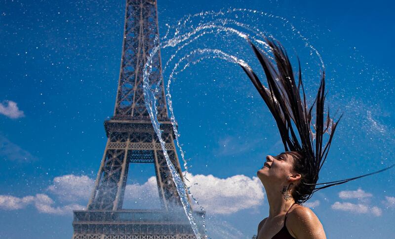A girl cools down in the fountains of Trocadero, across from the Eiffel Tower, during a heatwave in Paris, France.  According to forecast, the temperatures should rise to almost 40 degrees Celsius in the coming days.  EPA