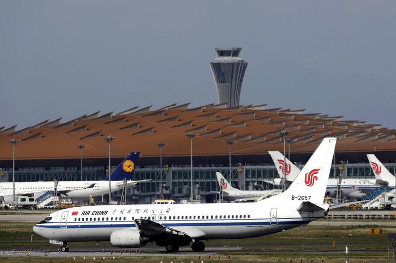 Air China passenger jets and a Lufthansa aircraft are seen at Terminal Three of Beijing Capital International Airport.  The two carriers have signed agreement designed to boost earnings. Petar Kujundzic / Reuters