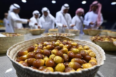 Emirati men check baskets of Dabas and Khalas dates during the annual Liwa Date Festival in the western region of Liwa on July 17, 2019. AFP