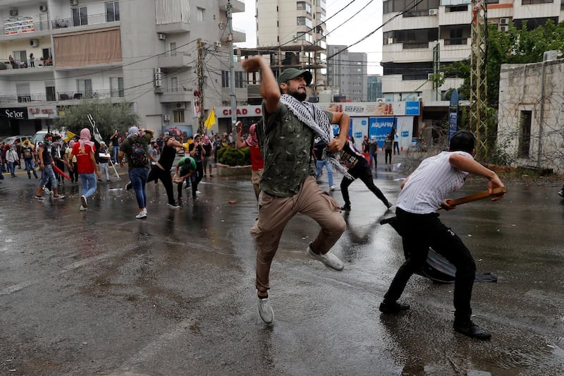 Hezbollah supporters and communist groups throw stones at riot police during a protest against US interference in Lebanon's affairs, near the American embassy in Aukar, north-east of Beirut, Lebanon. AP Photo