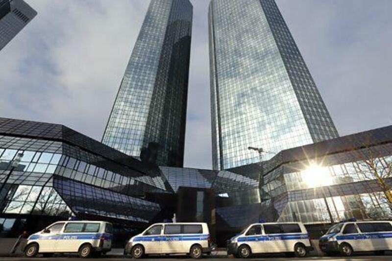 Police vehicles line up outside Deutsche Bank's Frankfurt HQ as part of an investigation into alleged involvement in tax evasion. Kai Pfaffenbach / Reuters