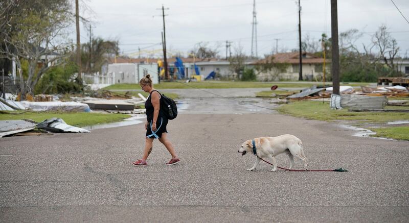 epa06167389 Local resident Valerie Cross, and her dog Boudreaux, walk home after visiting an aid center to get drinking water in the aftermath of Hurrican Harvey in Rockport, Texas, USA, 27 August 2017. Hurricane Harvey made landfall on the south coast of Texas as a major hurricane category 4, and was the worst storm to hit the city of Rockport in 47 years. The last time a major hurricane of this size hit the United States was in 2005.  EPA/DARREN ABATE