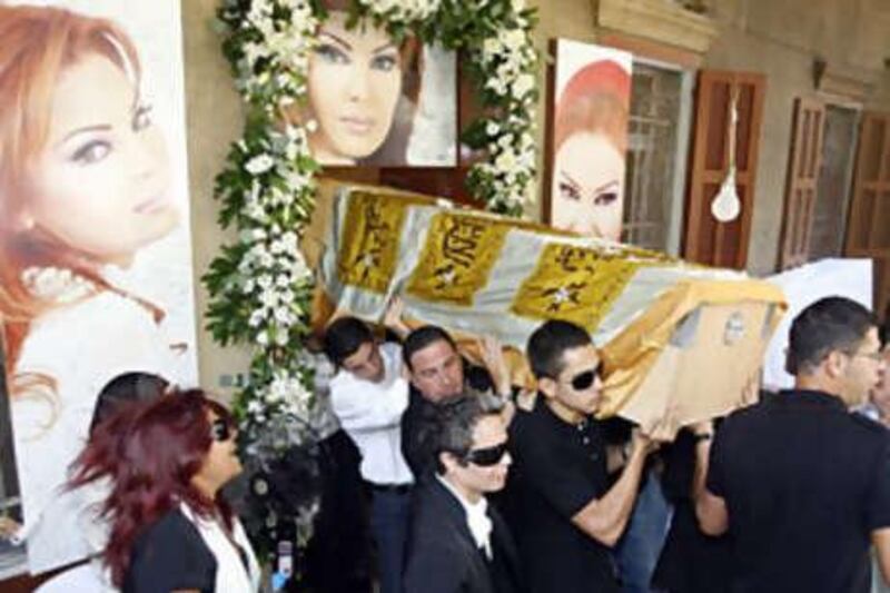 Relatives of murdered Lebanese singer Suzan Tamim carry her coffin.