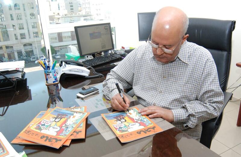 The first editor in chief of Majid Magazine, Ahmed Omar, signing replica copies of the magazine’s first edition dating from 1979. Courtesy Majid