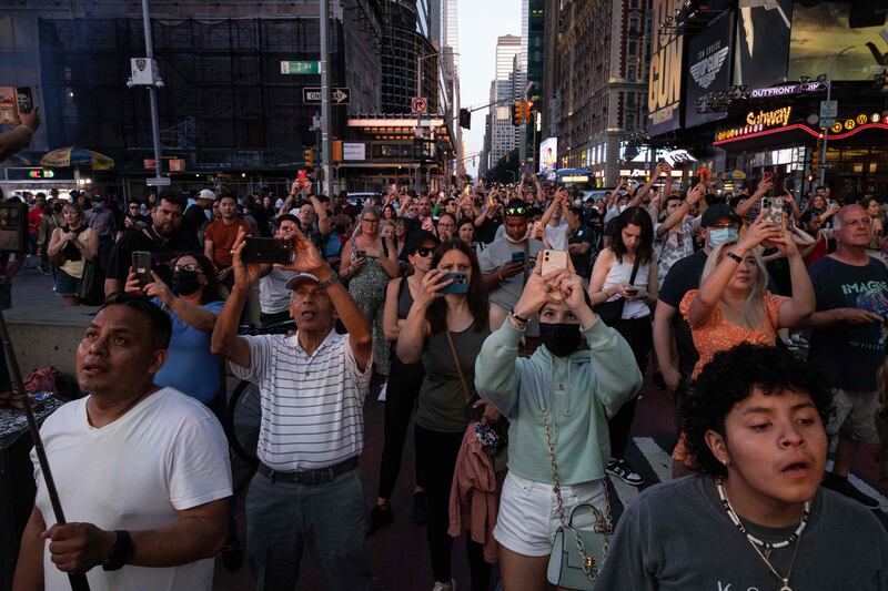 People take pictures on 42nd Street in Manhattan. AFP