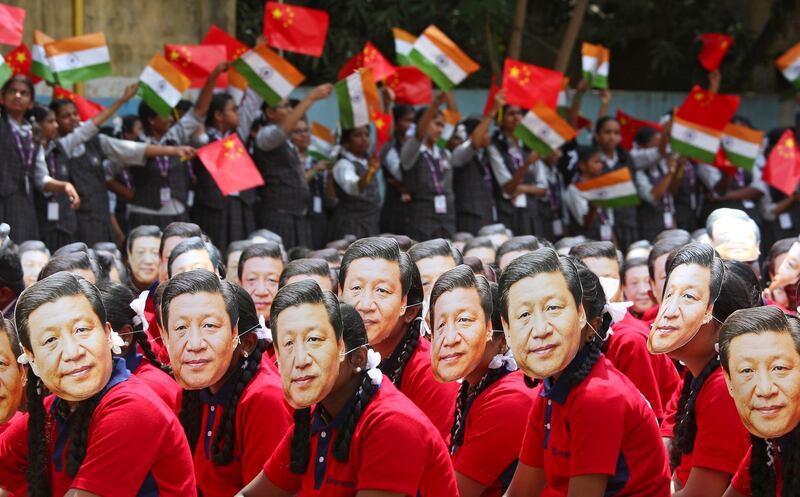 Students wear masks of China's President Xi Jinping in Chennai, India. Reuters