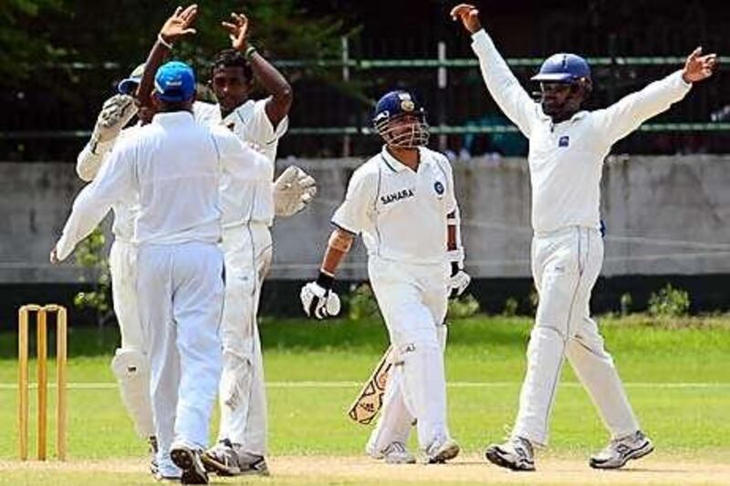 Sri Lanka Board XI's Ajantha Mendis, third from left, celebrates after the dismissal of India's Sachin Tendulkar on day two of a three-day practice match in Colombo yesterday. The off-spinner, however, has not been selected to play in the first Test at Galle.