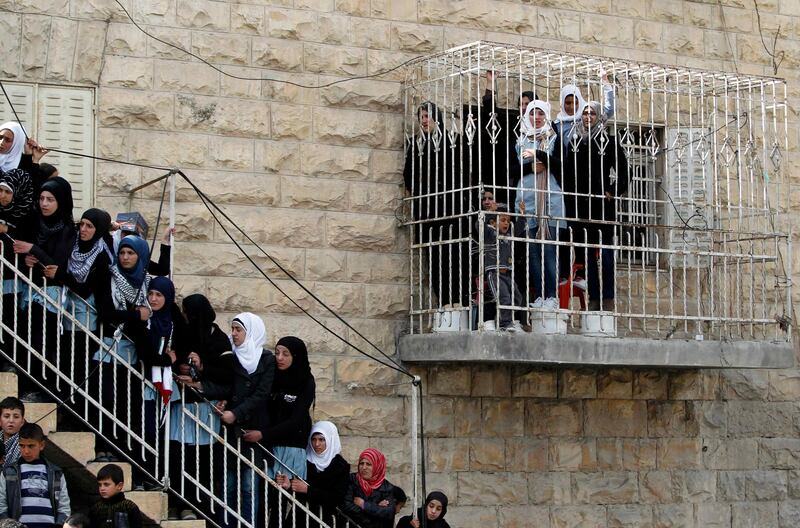 Palestinian women watch the funeral of Arafat Jaradat from a building in the West Bank village of Se'eer, near Hebron February 25, 2013. Israeli soldiers turned out in force on Monday for the funeral of Jaradat, who was arrested just one week ago for throwing stones at Israeli cars in the West Bank. Jaradat's death in an Israeli jail on Saturday and a hunger strike by four other prisoners have raised tension in the West Bank, where stone-throwers have clashed repeatedly with Israeli soldiers in recent days. REUTERS/Ammar Awad (WEST BANK - Tags: POLITICS CIVIL UNREST) *** Local Caption ***  JER13_PALESTINIANS-_0225_11.JPG