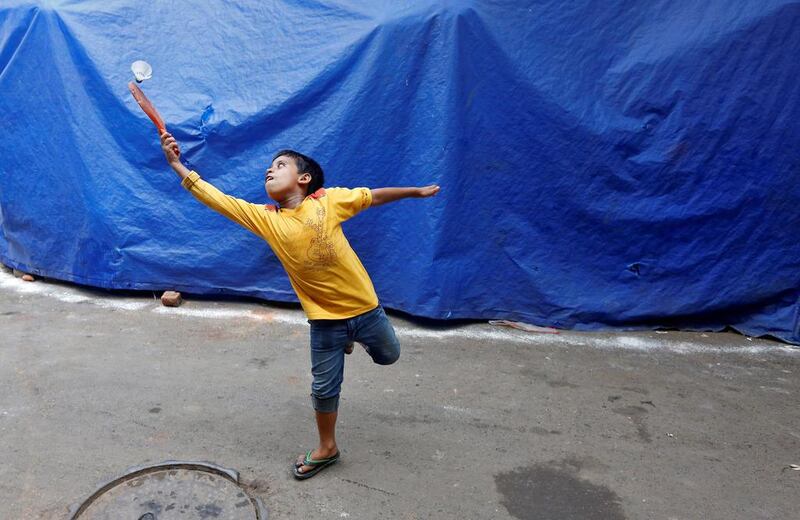 A young boy plays badminton in a slum area of Kolkata.  Rupak De Chowdhuri / Reuters