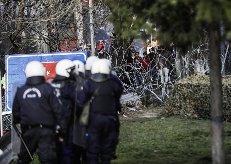 Greek riot police and the army hold positions as migrants toss rocks and other projectiles on the Greek-Turkish border gate in Kastanies, Greece. Getty Images