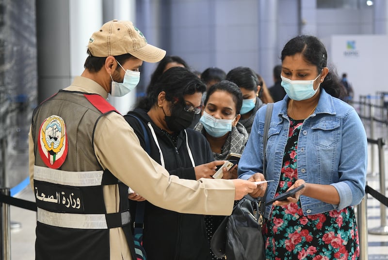 People arrive to receive Covid-19 vaccine doses at a facility in Kuwait City. EPA