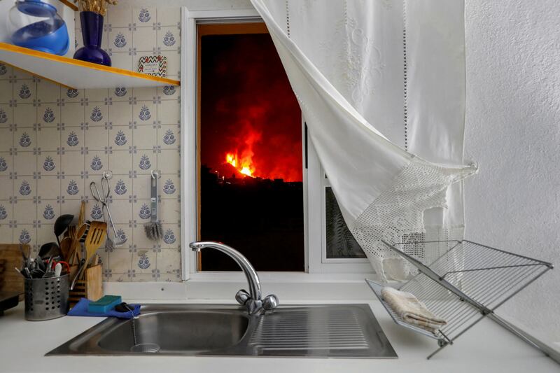 Lava is seen through a kitchen window in El Paso following the eruption of a volcano on the Canary Island of La Palma, Spain, on September 28, 2021. By Jon Nazca, Pulitzer Prize finalist for Feature Photography. Reuters