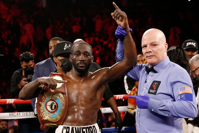 Terence Crawford poses for photographers after defeating Shawn Porter by TKO in a welterweight title boxing match Saturday, November  20, 2021, in Las Vegas. AP Photo