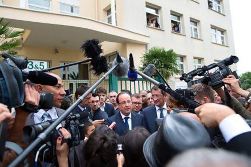 France's president Francois Hollande speaks with residents and journalists in Clichy-sous-Bois, outside Paris. Bertrand Langlois / AFP