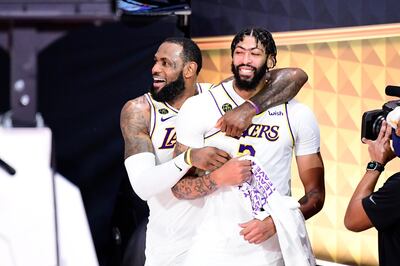 LAKE BUENA VISTA, FLORIDA - OCTOBER 11: LeBron James #23 of the Los Angeles Lakers and Anthony Davis #3 of the Los Angeles Lakers react after winning the 2020 NBA Championship in Game Six of the 2020 NBA Finals at AdventHealth Arena at the ESPN Wide World Of Sports Complex on October 11, 2020 in Lake Buena Vista, Florida. NOTE TO USER: User expressly acknowledges and agrees that, by downloading and or using this photograph, User is consenting to the terms and conditions of the Getty Images License Agreement.   Douglas P. DeFelice/Getty Images/AFP