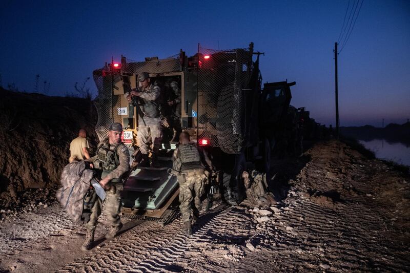 The first group of Turkish infantry prepare to enter Syria on the border between Turkey and Syria on October 9 in Akcakale, Turkey. Getty Images