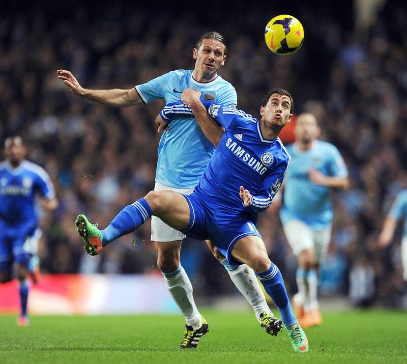 Manchester City's Martin Demichelis, left, and Chelsea's Eden Hazard tangle for the ball during their English Premier League match at Etihad Stadium on Monday. Clint Hughes / AP Photo