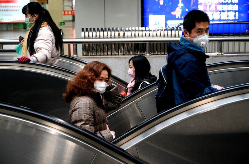 Subway passengers wear protective facemasks in Shanghai. AFP