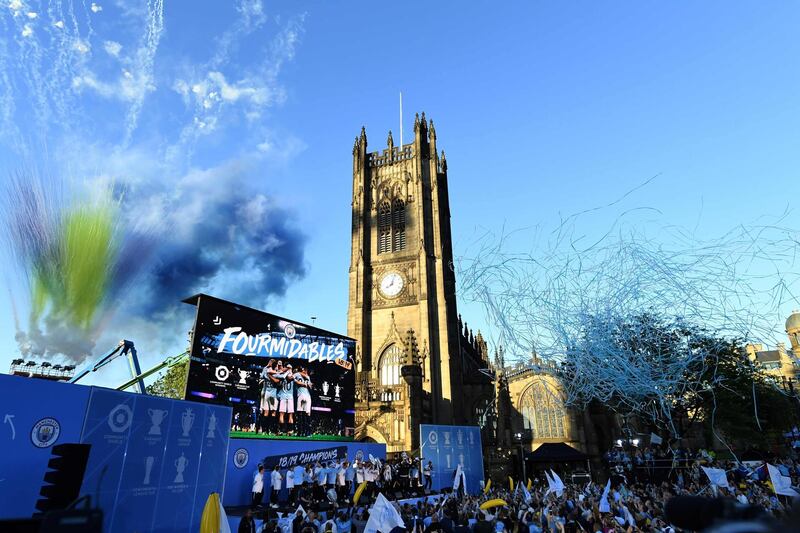 Manchester City players take part in a stage presentation following an open-top bus parade through Manchester, northern England, to celebrate winning the 2019 Premier League title, the FA Cup and English League Cup. Pep Guardiola saluted Manchester City's history makers after they clinched the domestic treble with a swaggering 6-0 rout of Watford in the FA Cup final on Saturday. Just a week after winning a second successive Premier League crown, City's record-equalling FA Cup final victory made them the first English club to win the English title, FA Cup and League Cup in the same season.  AFP