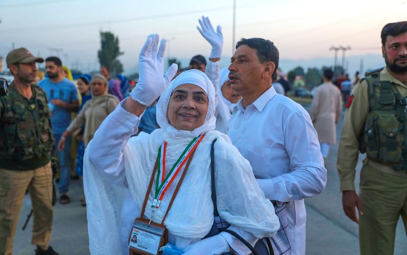 Kashmiri Muslim pilgrims wave as they leave for the Hajj. EPA