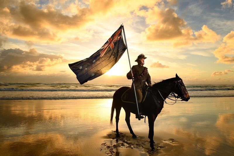 Chris Kennedy and his horse Chaos pose for photos on Currumbin Beach ahead of Anzac Day on the Gold Coast, Australia. EPA