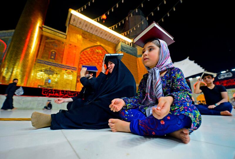 Shiite Muslims gather, albeit in fewer numbers due to the COVID-19 pandemic, at the Imam Ali shrine in the central Iraqi holy city of Najaf, to mark Lailat al-Qadr, a night in the holy month of Ramadan during which the Koran was first revealed to the Prophet Mohammed in the seventh century.  AFP