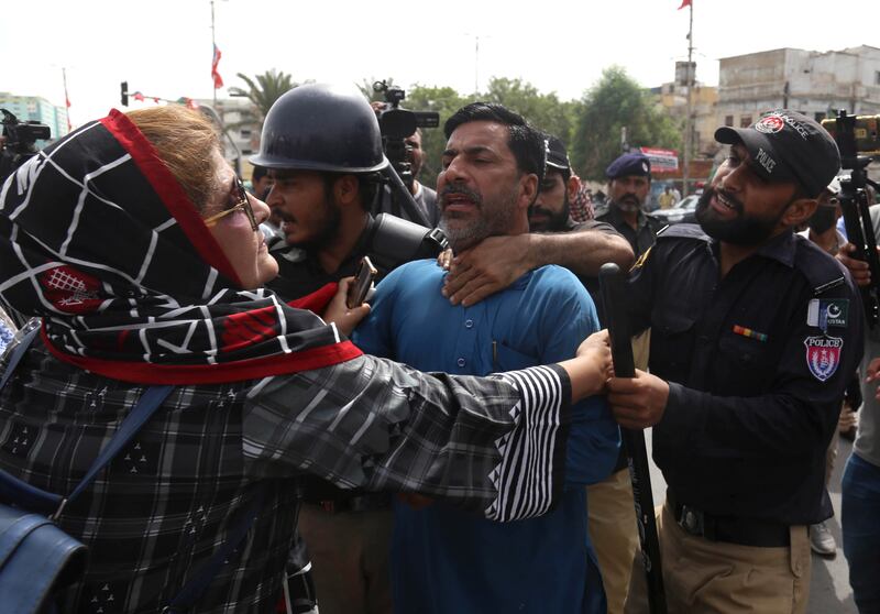 PTI supporters clash with police in Karachi. EPA