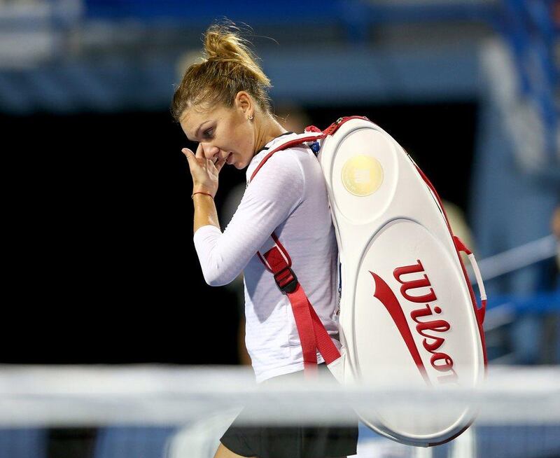 Simona Halep walks off the court after her loss to Magdalena Rybarikova at the second round of the WTA Connecticut Open on Tuesday. Elsa / Getty Images / August 19, 2014