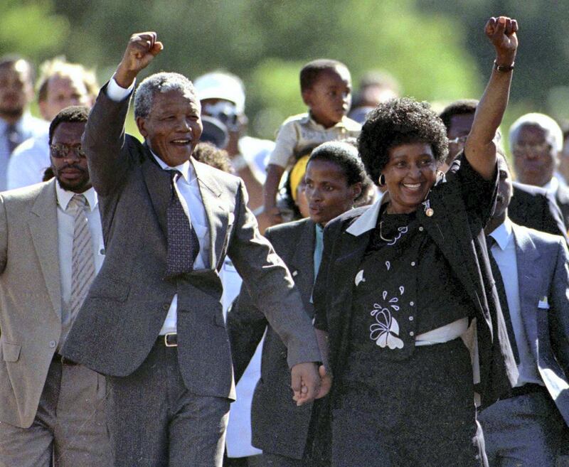 Nationalist leader Nelson Mandela (L) gestures as he is accompanied by his wife Winnie, moments after his release from Victor Verster prison in Western Cape in this February 11, 1990 file photo. Twenty years after Mandela was freed from prison, South Africa is a vibrant democracy but the millions still living in poverty are now looking for leadership that can tackle its economic problems. Mandela's release on Feb. 11, 1990, after 27 years in apartheid-era jails, set in motion the country's transformation to democracy which culminated in historic all-race elections in 1994 and his inauguration as the country's first black leader.   REUTERS/Ulli Michel/Files   (SOUTH AFRICA - Tags: POLITICS ANNIVERSARY) *** Local Caption ***  SSIB01_SAFRICA-MAND_0209_11.JPG