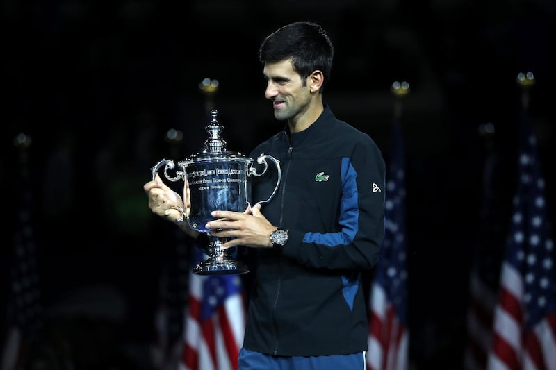 NEW YORK, NY - SEPTEMBER 09: Novak Djokovic of Serbia poses with the championship trophy after winning his men's Singles finals match against Juan Martin del Potro of Argentina on Day Fourteen of the 2018 US Open at the USTA Billie Jean King National Tennis Center on September 9, 2018 in the Flushing neighborhood of the Queens borough of New York City.   Matthew Stockman/Getty Images/AFP
== FOR NEWSPAPERS, INTERNET, TELCOS & TELEVISION USE ONLY ==
